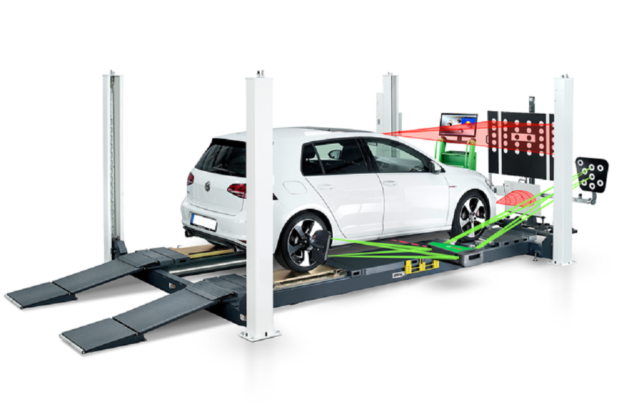 Professional ADAS calibration equipment being used to align a vehicle’s windshield-mounted camera in an automotive service bay